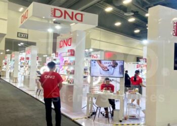 A group of people in front of a trade show display rentals in Las Vegas